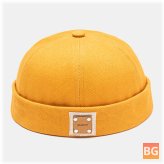 All-match beanie with a solid color rivet on the front and a polyester label