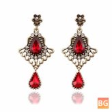 Ethnic Tassel Earrings with Drop-shaped Ruby Glass