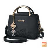 Lady's shoulder bag with faux leather flowers and chain strap