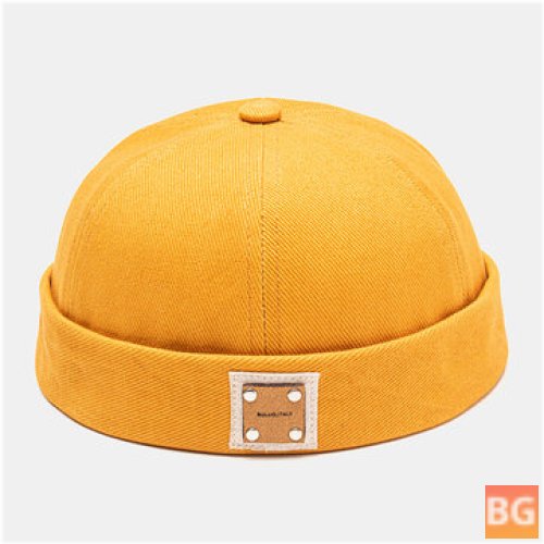 All-match beanie with a solid color rivet on the front and a polyester label