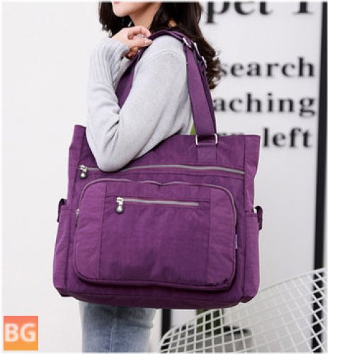 Women's messenger diaper bag with a lot of pockets and a shoulder strap
